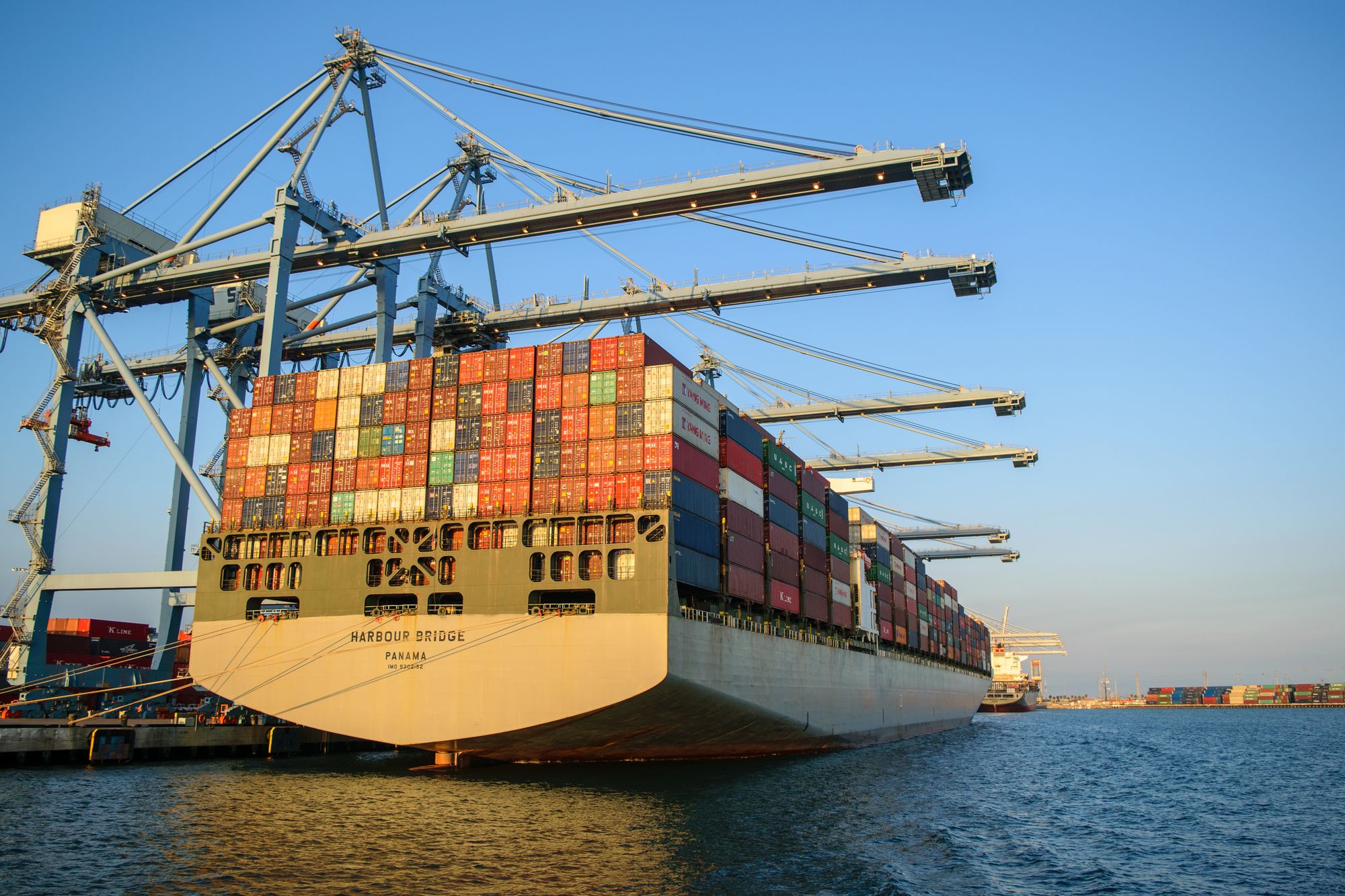 A container ship loaded with cargo at a busy port.